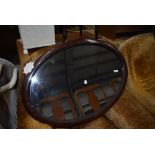 An over mantle mirror having oval scumbal finished frame
