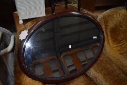 An over mantle mirror having oval scumbal finished frame