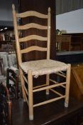 A beech framed ladder back chair having rush seat