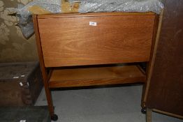 A vintage teak effect tea trolley