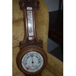 An early 20th Century oak cased aneroid barometer with thermometer to stem