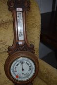 An early 20th Century oak cased aneroid barometer with thermometer to stem