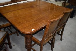 A 19th Century Gillow and Co oak extending dining/banquetting table, having turned legs, brass cast