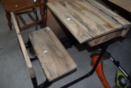 An early school desk having iron frame work with pine seat and desk