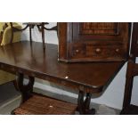 A vintage oak veneered refectory style dining table, rose motif to frieze