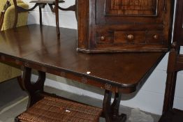 A vintage oak veneered refectory style dining table, rose motif to frieze