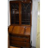 An early 20th Century mahogany and walnut bureau bookcase