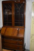 An early 20th Century mahogany and walnut bureau bookcase