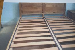 A modern light oak king size bed frame, with drawer storage, disassembled for ease of transport