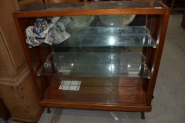 A vintage pitch pine display case with mirror back