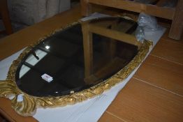 A vintage gilt frame oval wall mirror