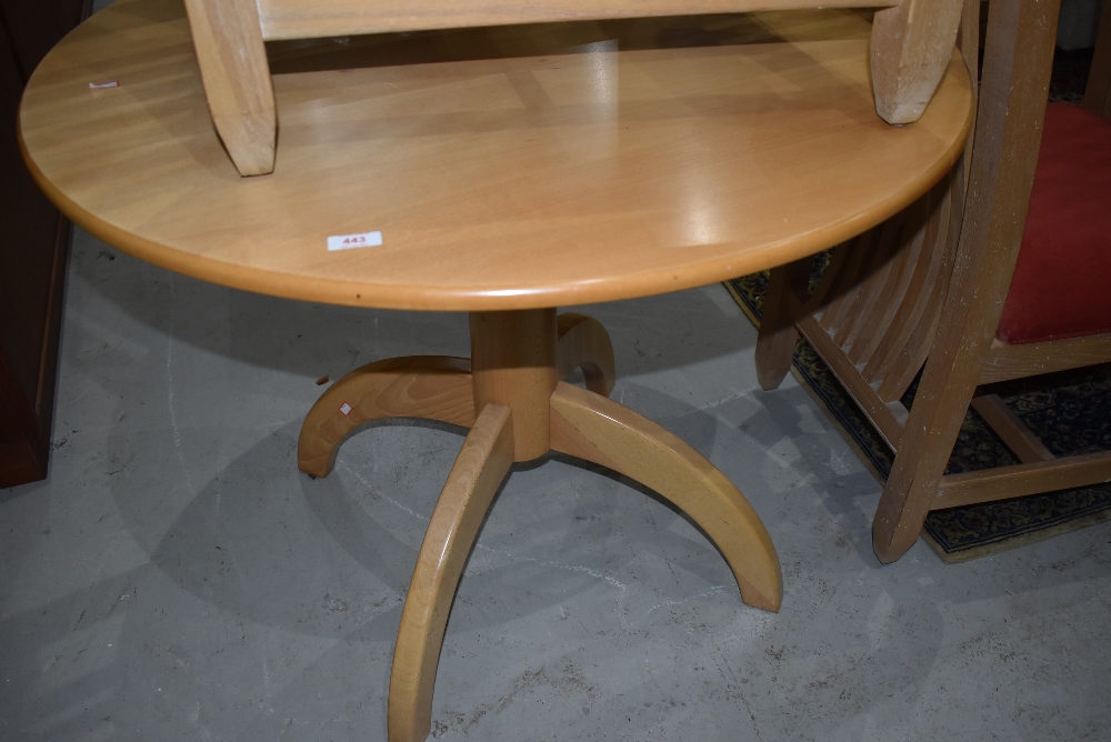 A modern beech effect having rocket style quadruple legged base, diameter approx 91cm