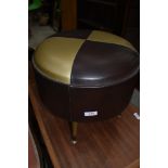 A mid century atomic style foot stool in vinyl