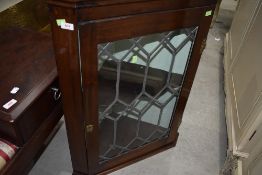 A Victorian mahogany cased corner wall unit having leaded light door and H hinges