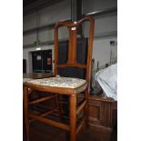 A traditional 20th century bedroom chair having turned oak frame