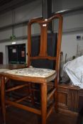 A traditional 20th century bedroom chair having turned oak frame