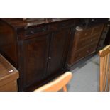A Victorian mahogany shallow sideboard, two small drawers over double cupboard, on scroll feet