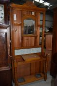 A late Victorian light stained hallway hat cloak and coat stand having tiled back and mirror