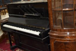 A traditional upright piano having ebonised case, labelled and impressed for Duck , Son & Pinker