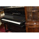 A traditional upright piano having ebonised case, labelled and impressed for Duck , Son & Pinker