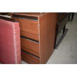 A laminate three drawer filing cabinet