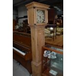 A lang case clock having stripped pine carcass with hand painted face and column hood