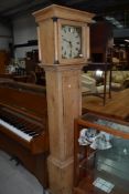 A lang case clock having stripped pine carcass with hand painted face and column hood