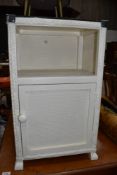 A woven fibre bedside or bathroom cabinet with cupboard base