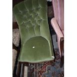 A traditional Victorian nursing chair having button back upholstery in green