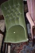 A traditional Victorian nursing chair having button back upholstery in green