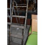 A set of fold away metal framed wooden step ladders