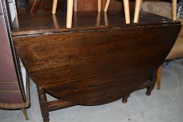 A drop leaf kitchen table having soil oak frame work with turned legs