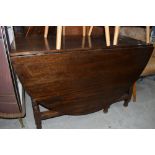 A drop leaf kitchen table having soil oak frame work with turned legs