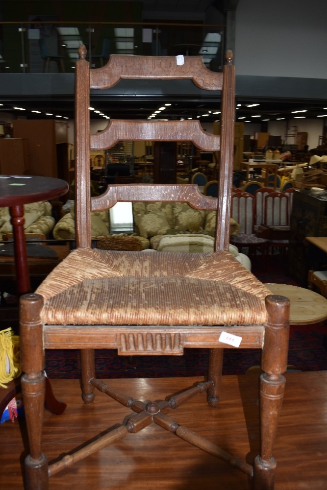 An interesting and naive style rush seated ladderback chair, having turned cross stretcher