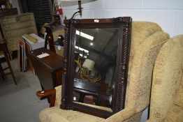 A 19th Century mahogany wall mirror having twist pillar decoration