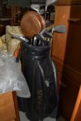 A selection of golf clubs including King Cobra and Daiwa, with bag and balls