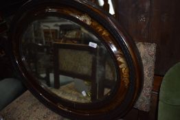 An impressive antique hall way oval mirror having carved and decorated frame with bevel edge glass