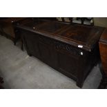 A Period carved oak kist or coffer having heavy veneer frontage with pegged carcass