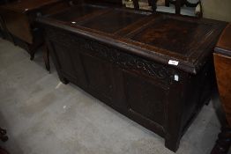 A Period carved oak kist or coffer having heavy veneer frontage with pegged carcass