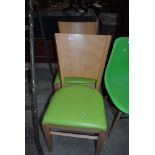 A pair of beech and ply kitchen dining chairs, having lime green vinyl seats, labelled Pineapple