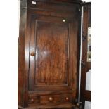 A Victorian corner cupboard having decorated veneer front with integral draw sets