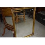 A reproduction gilt frame wall mirror