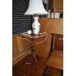 A reproduction wine table and a Masonware table lamp