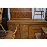 A pine shop counter or sideboard, four four and three drawers configuration with brass campaign