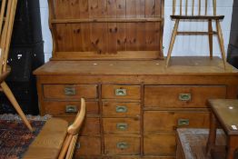 A pine shop counter or sideboard, four four and three drawers configuration with brass campaign