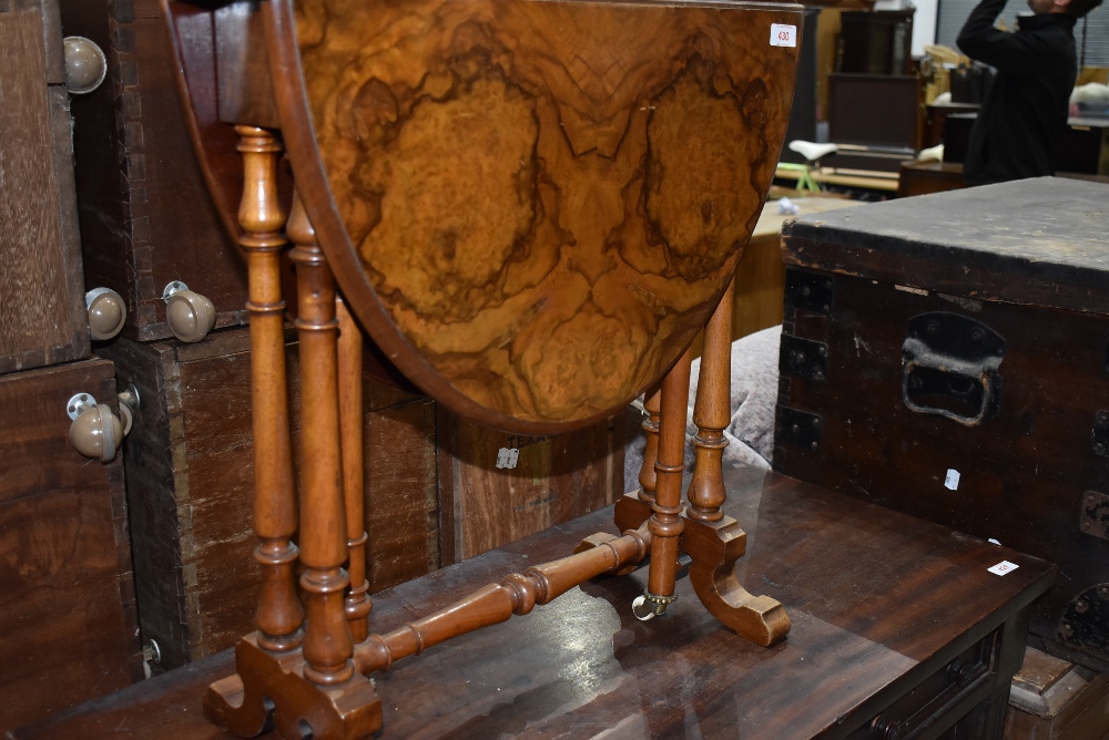 A 19th Century walnut Sutherland style occasional table, having turned frame, brass and pot casters