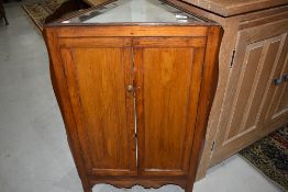 An interesting oak triangular corner cupboard having illusionary bijouterie top, possibly having