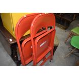 A pair of red metal fold away chairs retailed by Habitat