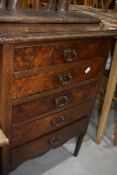 An early 20th Century mahogany and walnut chest of drawers, music style but with fixed drawer