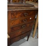 An early 20th Century mahogany and walnut chest of drawers, music style but with fixed drawer